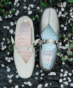 Rockfish Weatherwear X MINJUKIM Bliss Ribbon Sneakers Charcoal with Cream, top view among petals