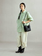 Songmont Lattice Bucket Bag Onyx - worn cross-body