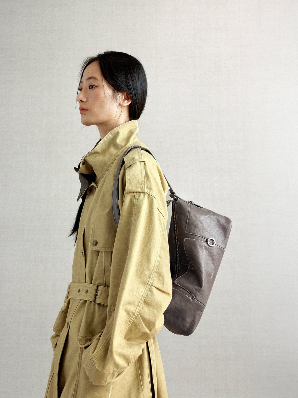 Songmont H Yore Bag Ink Grey - worn on the back with a khaki trench coat