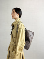 Songmont H Yore Bag Ink Grey - worn on the back with a khaki trench coat