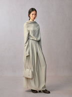 Songmont Small Yore Trunk Bag Cloud - carried by hand at the side in a long pale dress