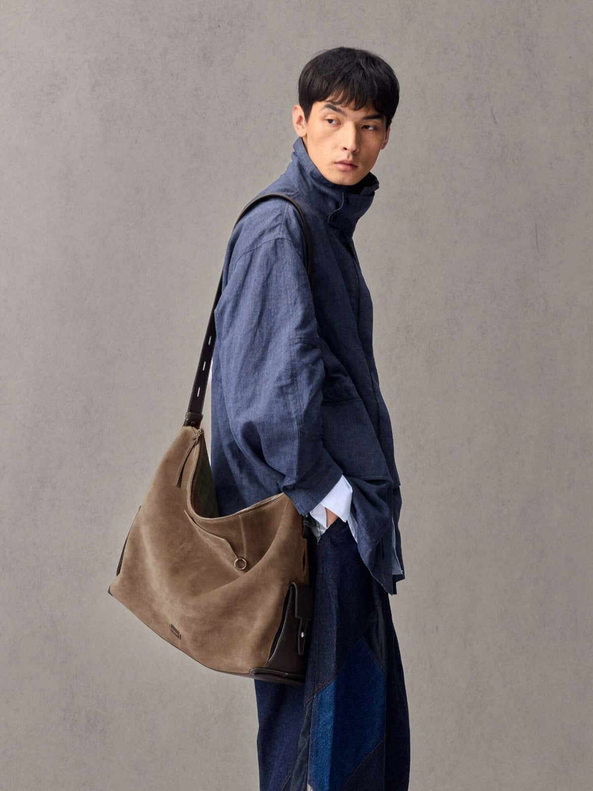 Songmont Extra Large Yore Hobo Bag Stone - worn across the body with a blue linen shirt