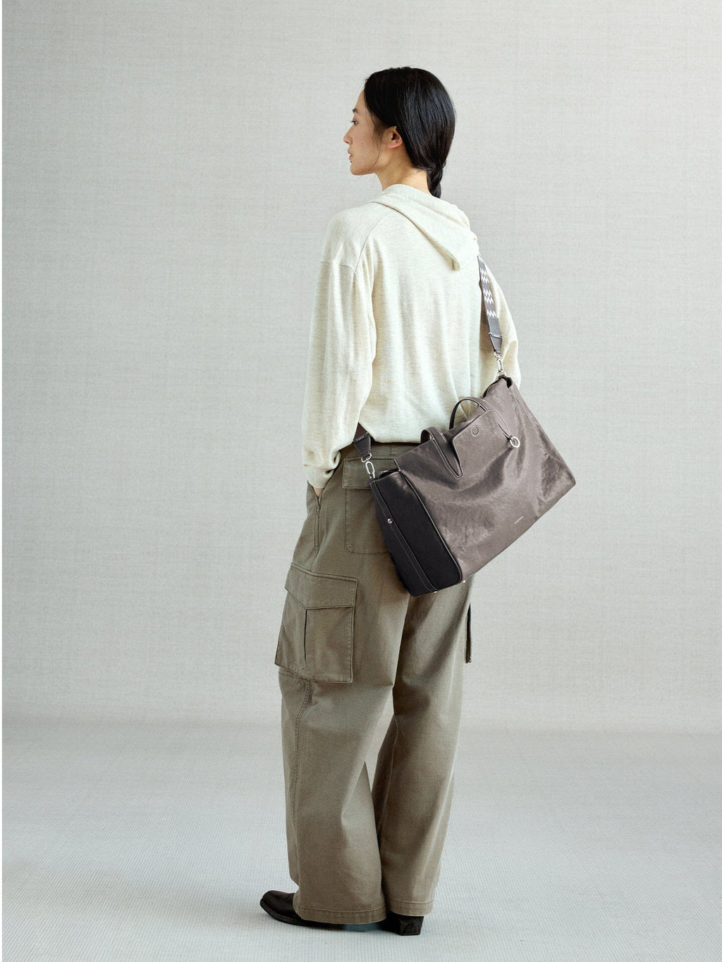 Songmont Medium Yore Duffle Bag Ink Grey - worn cross-body, back view