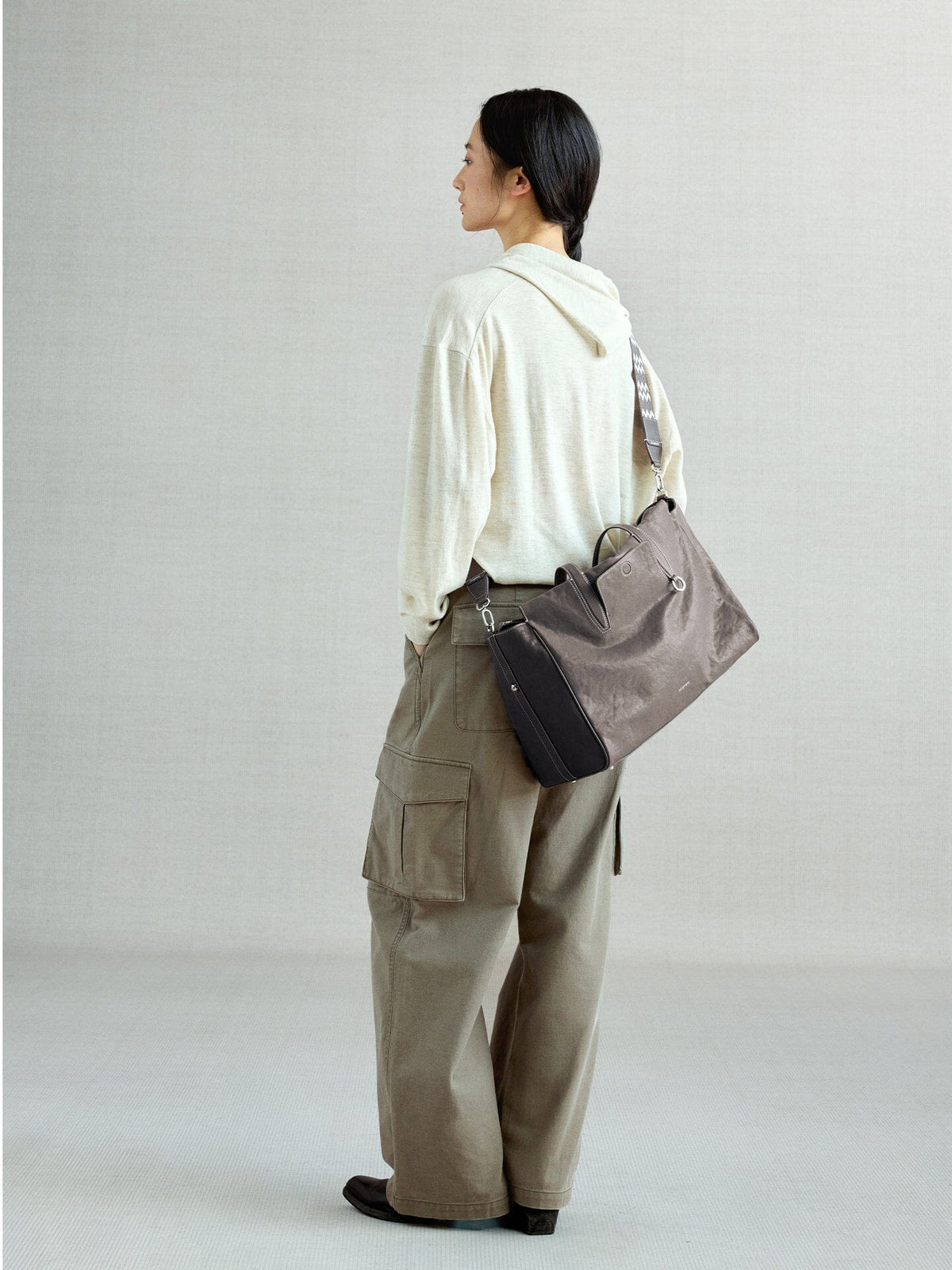 Songmont Medium Yore Duffle Bag Ink Grey - worn cross-body, back view