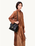 Songmont Small Shan Backpack Onyx - worn cross-body on the shoulder