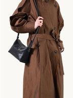 Songmont Small Yore Hobo Bag (Minimal Version) Onyx - worn crossbody with a trench coat