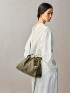 Songmont Small Gather Bag Dark Pine Green worn on the shoulder