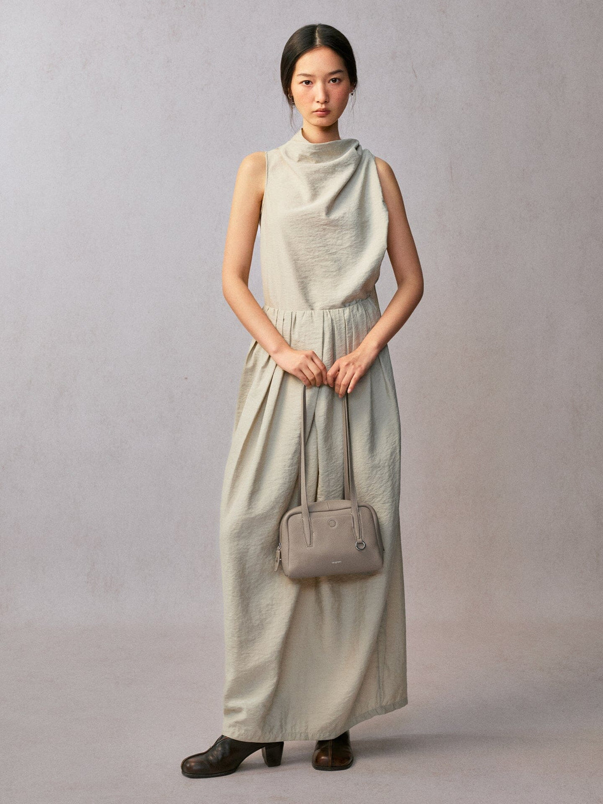 Songmont Small Yore Trunk Bag Smoke Grey - held in front with both hands