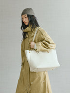 Songmont Large Yore Tote Bag Cloud - carried on the shoulder with a trench coat