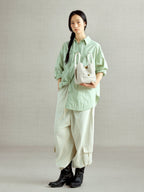 Songmont Lattice Bucket Bag Cloud - carried by hand