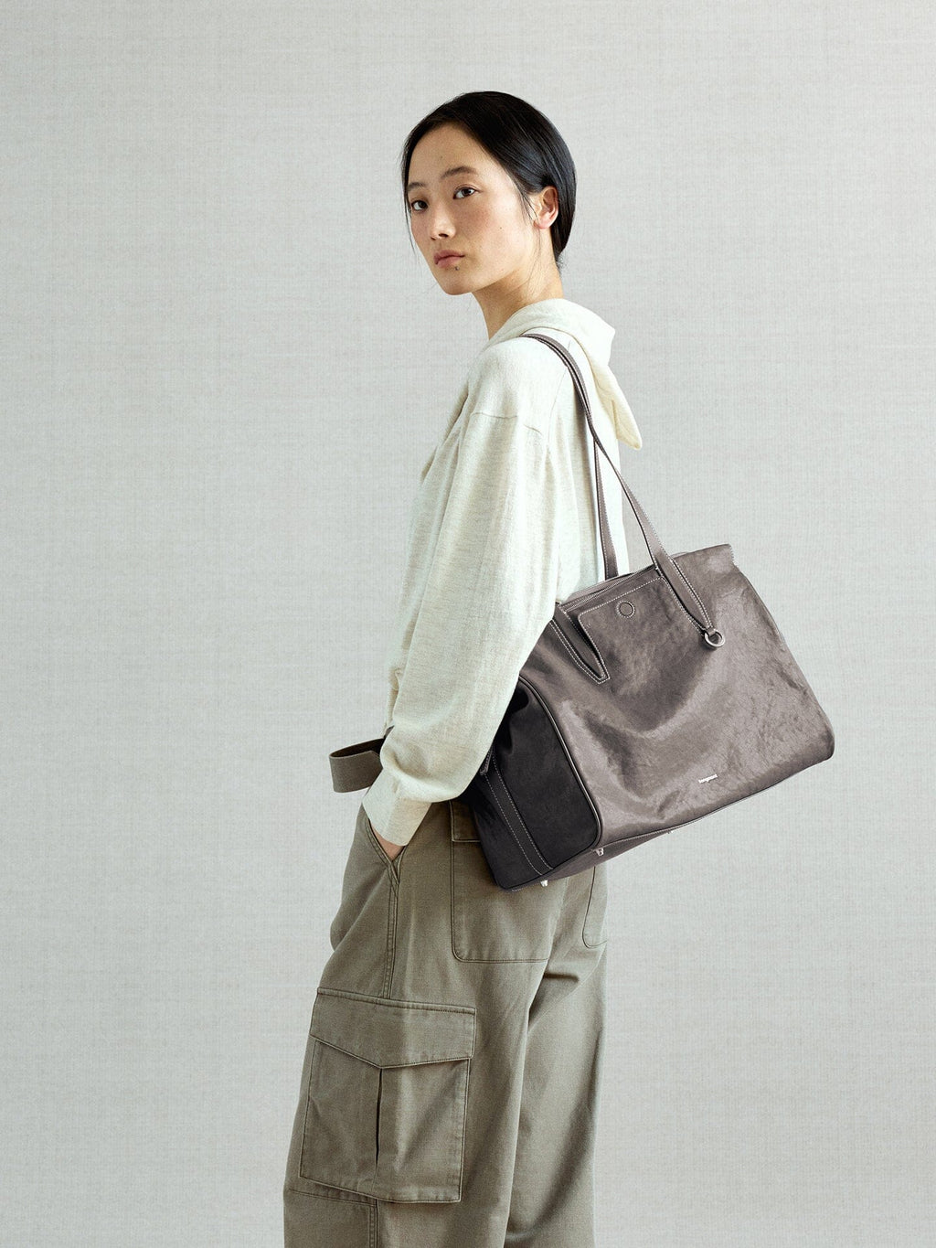 Songmont Medium Yore Duffle Bag Ink Grey - carried on the shoulder, three-quarter view