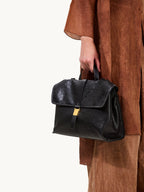 Songmont Small Shan Backpack Onyx - carried by the top handle