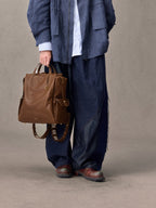 Songmont Small Yore Backpack Sandal - carried by hand, front view