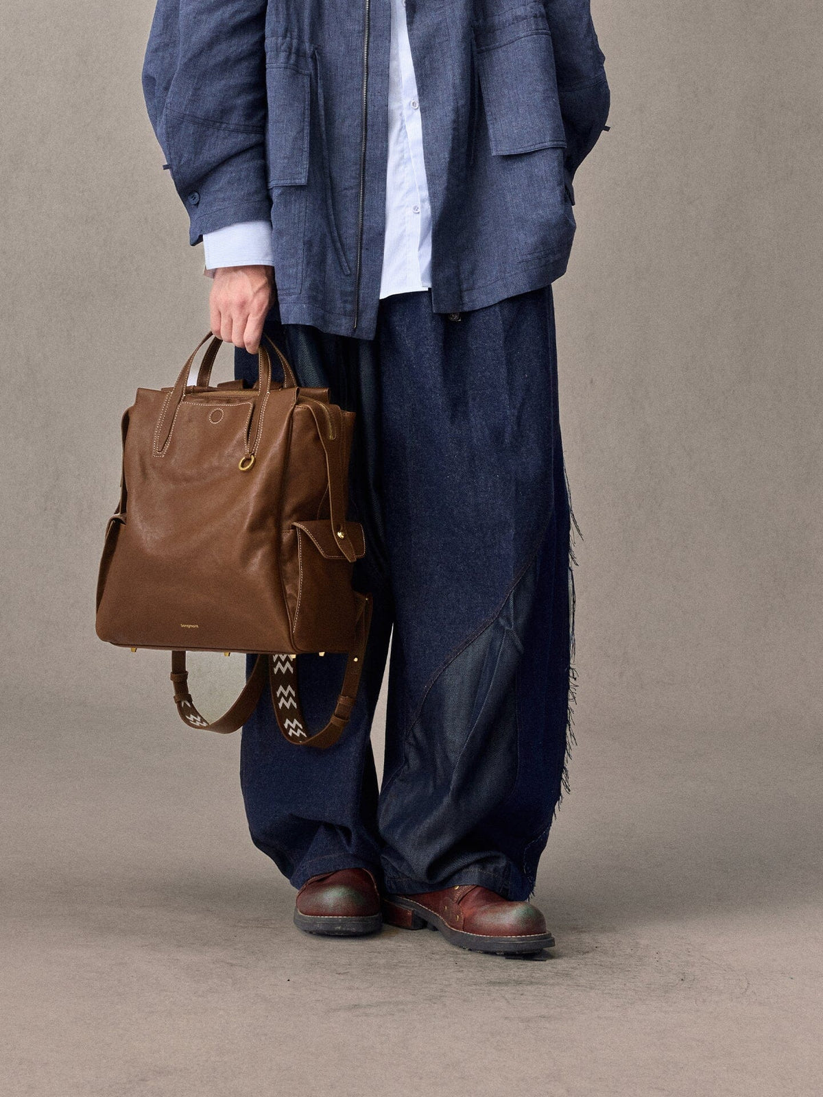 Songmont Small Yore Backpack Sandal - carried by hand, front view