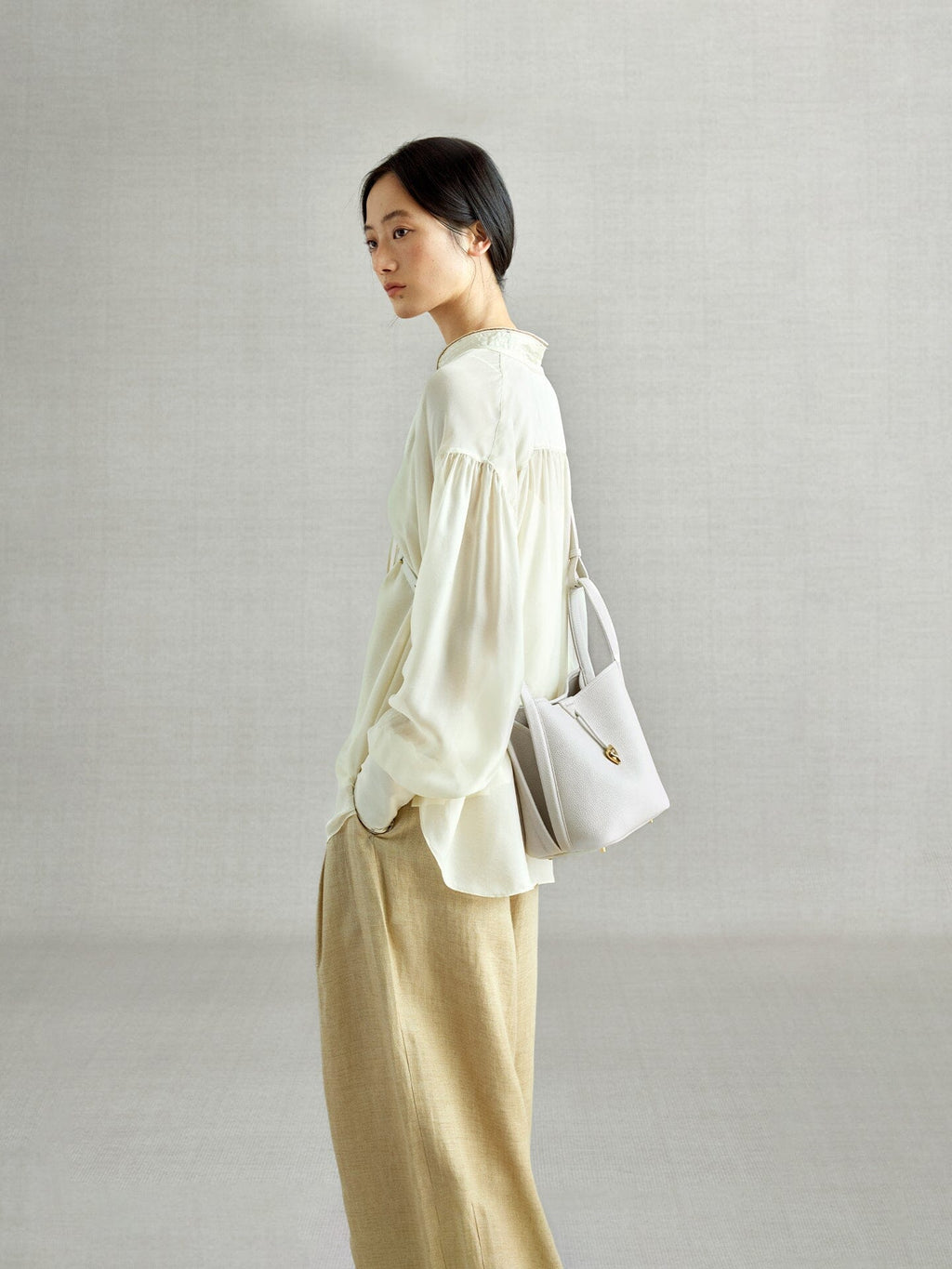 Songmont Song Bucket Bag Cloud - worn cross-body, side view