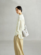 Songmont Song Bucket Bag Cloud - worn cross-body, side view