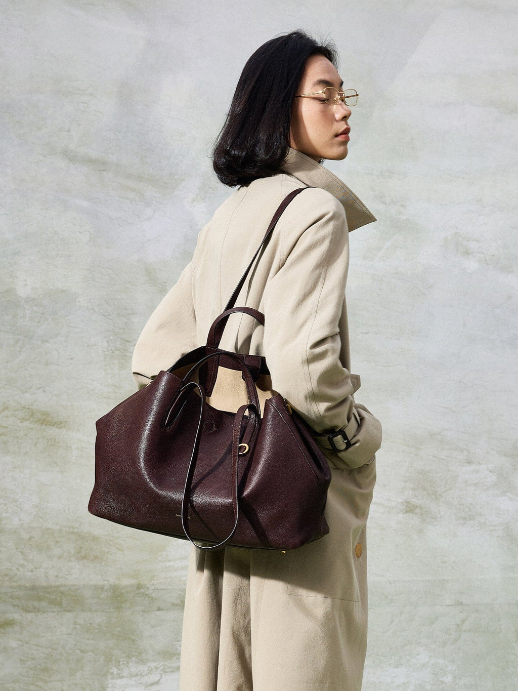 Songmont Large Yore Tote Bag Raisin - worn on the shoulder with a trench coat