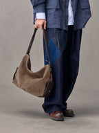 Songmont Large Yore Hobo Bag Stone - carried by the strap at the side