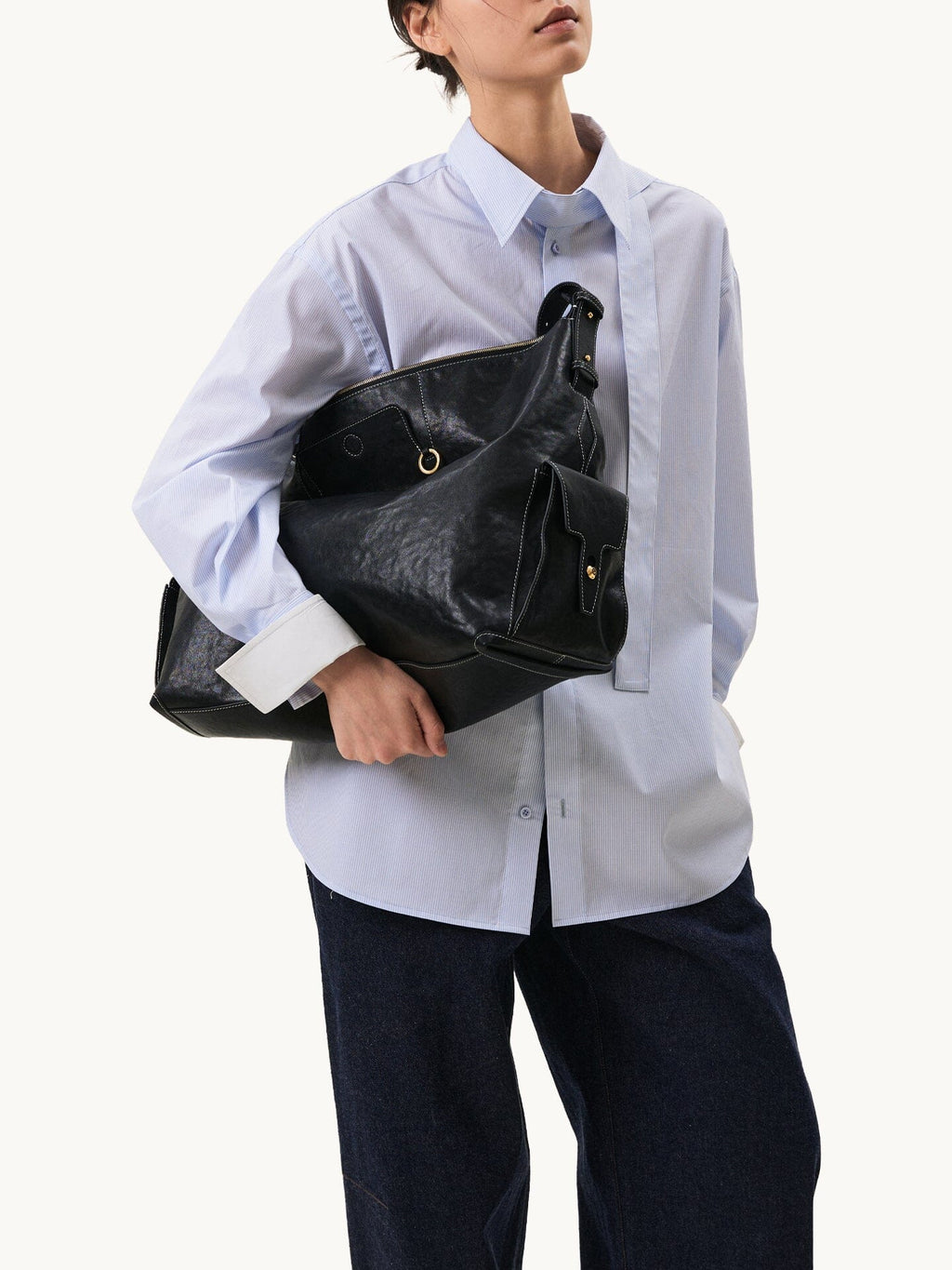 Songmont Extra Large Yore Hobo Bag Onyx - carried in the arm with a pale blue shirt