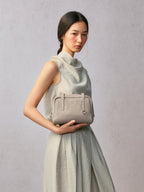 Songmont Small Yore Trunk Bag Smoke Grey - tucked in the crook of the arm