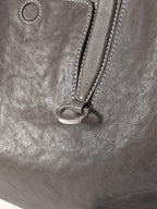 Songmont Medium Yore Duffle Bag Ink Grey - close-up of handle ring and leather grain