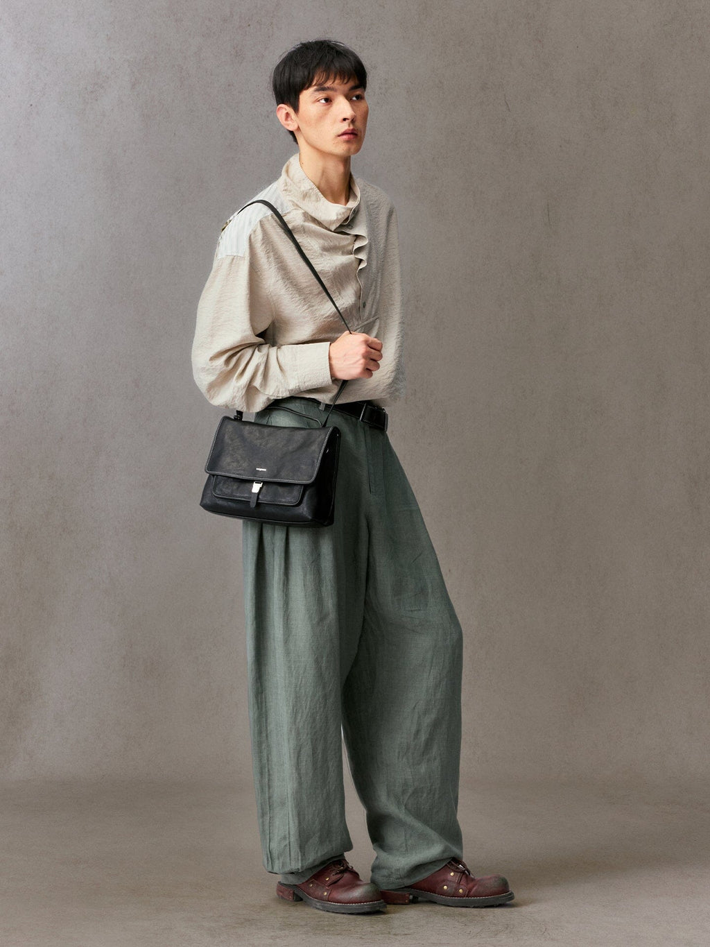 Songmont Small Shan Messenger Bag Onyx - worn at the hip, front view of the flap and pocket