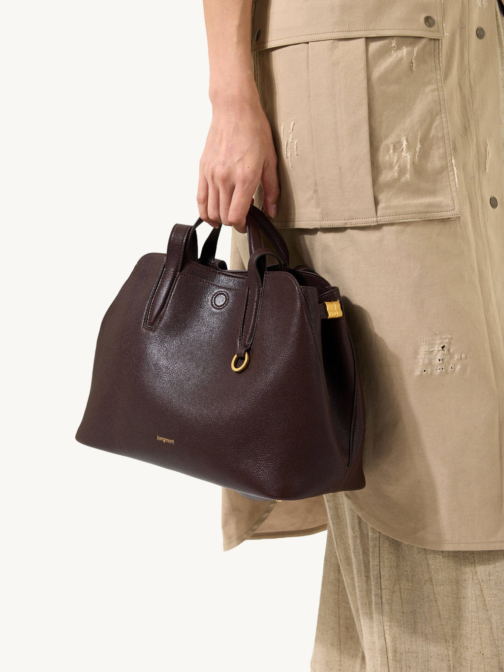 Songmont Small Yore Tote Bag Raisin - carried by the top handle