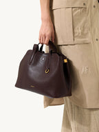 Songmont Small Yore Tote Bag Raisin - carried by the top handle