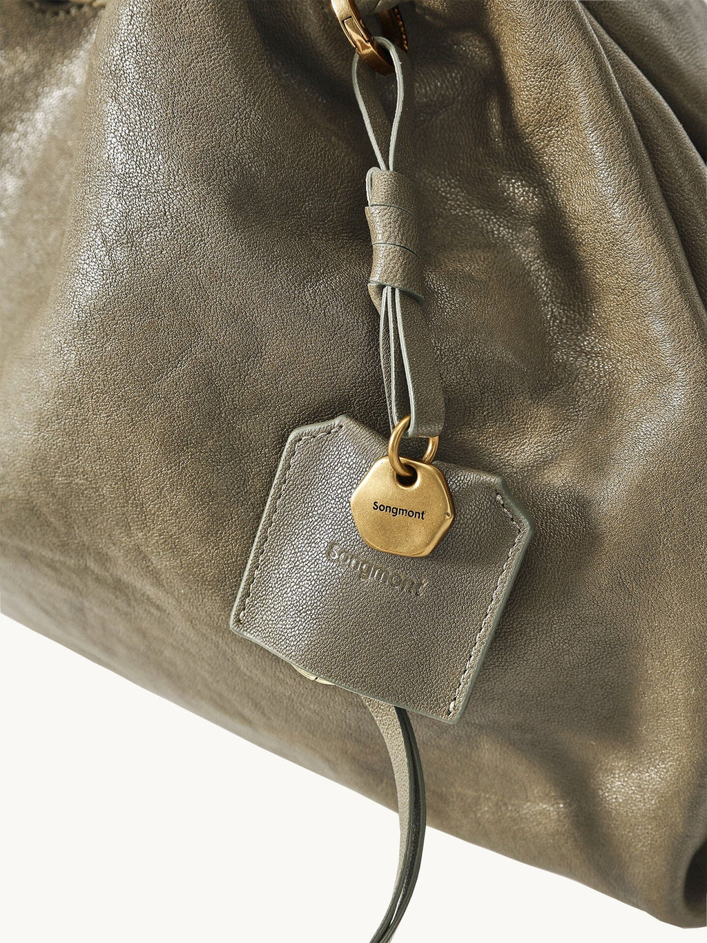 Songmont Small Gather Bag Dark Pine Green leather and charm detail