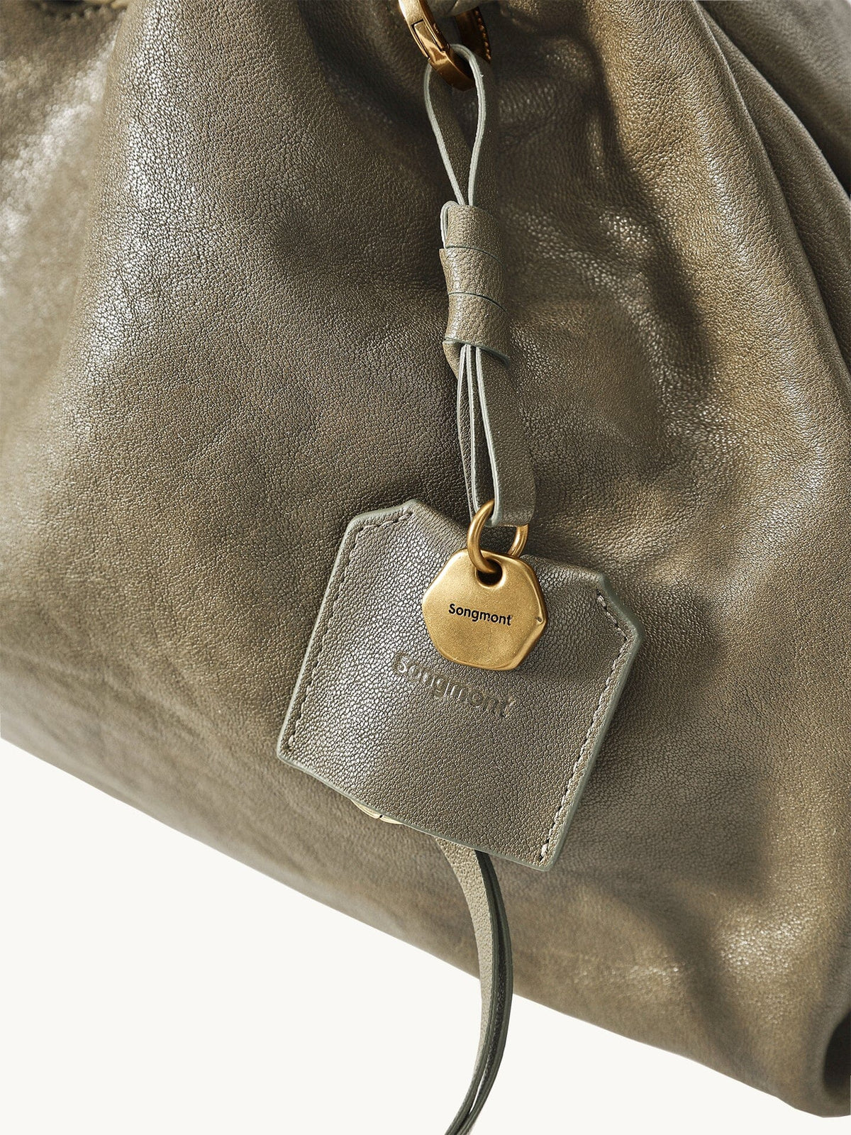 Songmont Small Gather Bag Dark Pine Green leather and charm detail