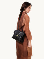 Songmont Small Shan Backpack Onyx - worn on the shoulder, side view