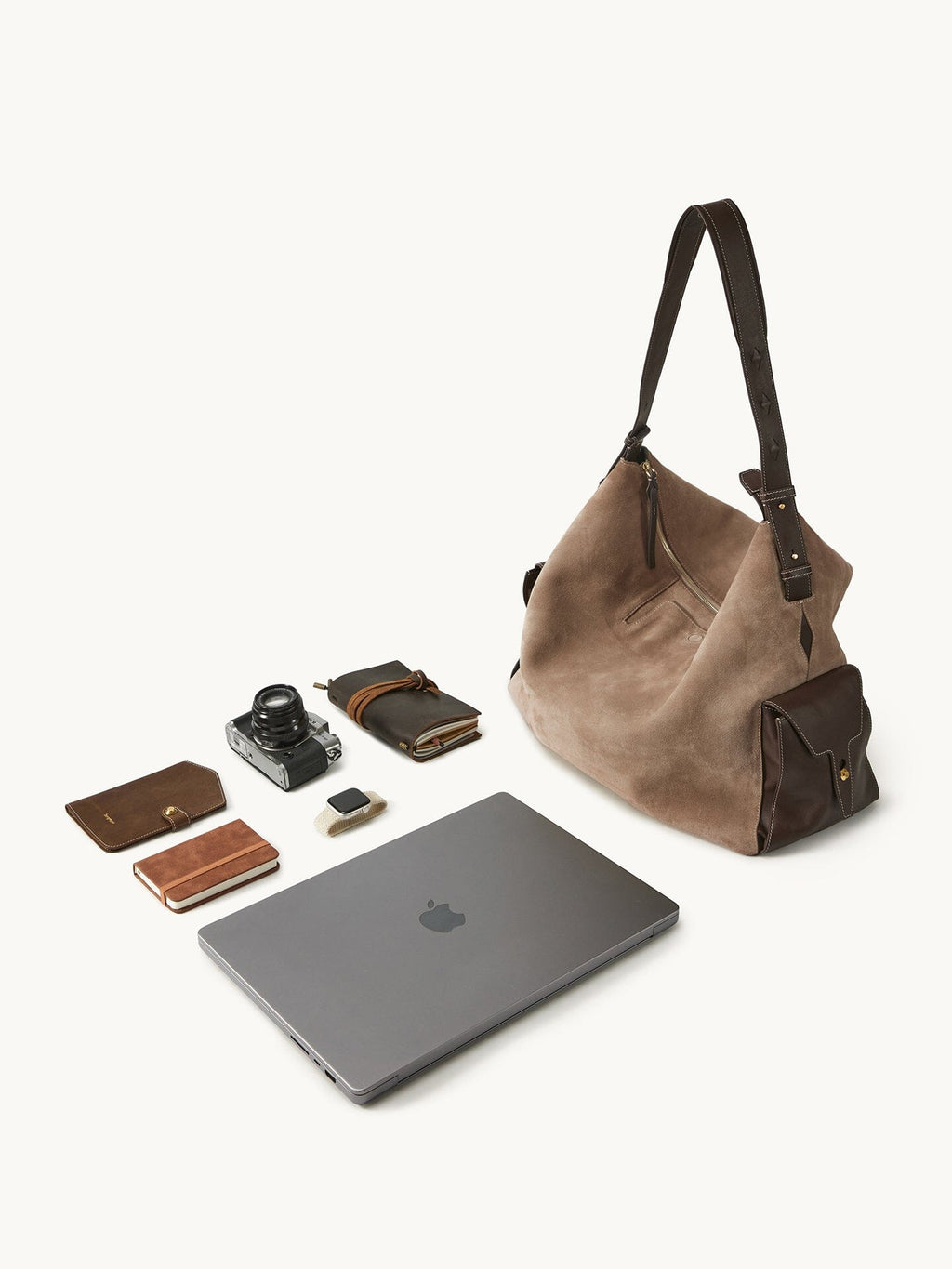 Songmont Extra Large Yore Hobo Bag Stone - flat lay with laptop, camera and notebook