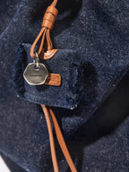 Songmont Medium Gather Backpack Set Indigo - close-up of the charm and tag