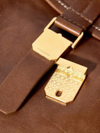 Songmont Small Shan Backpack Sandal - gold-toned book clasp close-up