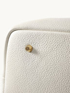 Songmont Large Yore Tote Bag Cloud - close-up of the grain and gold stud at the corner