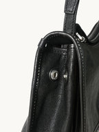 Songmont Small Shan Messenger Bag Onyx - side close-up of the strap, flap edge and snap