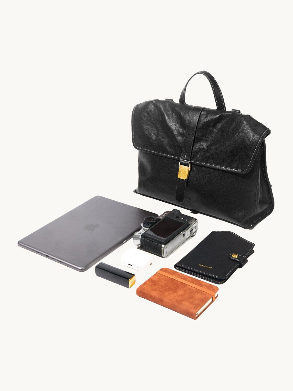 Songmont Small Shan Backpack Onyx - flat lay with a laptop, camera and notebook