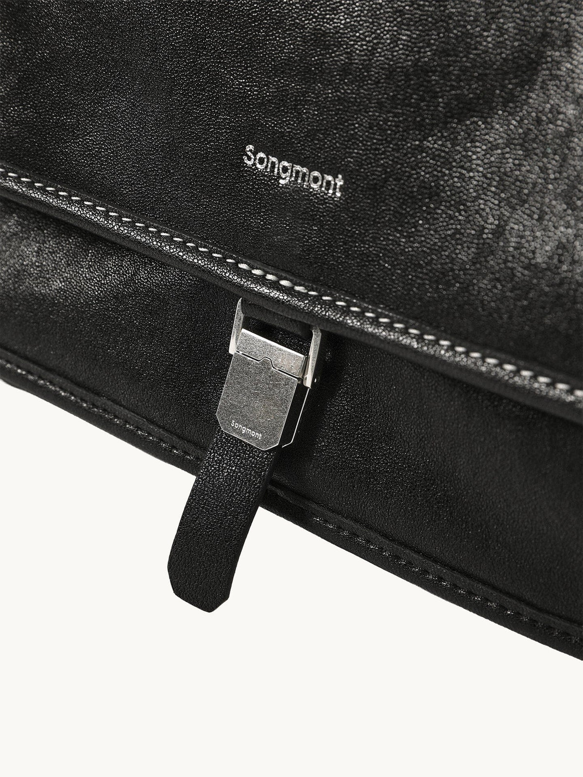 Songmont Medium Shan Messenger Bag Onyx - logo and buckle clasp close-up
