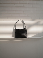MONOROW Vena Bag Black flat lay woven texture
