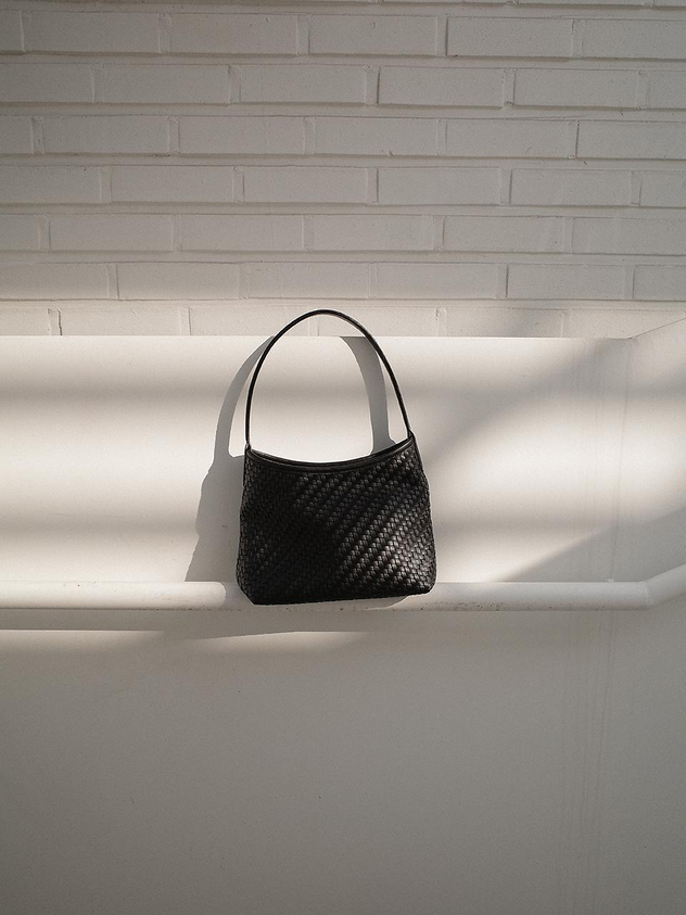 MONOROW Vena Bag Black flat lay woven texture