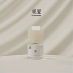 TO SUMMER Nude Eau de Parfum 30ml bottle on cream draped fabric