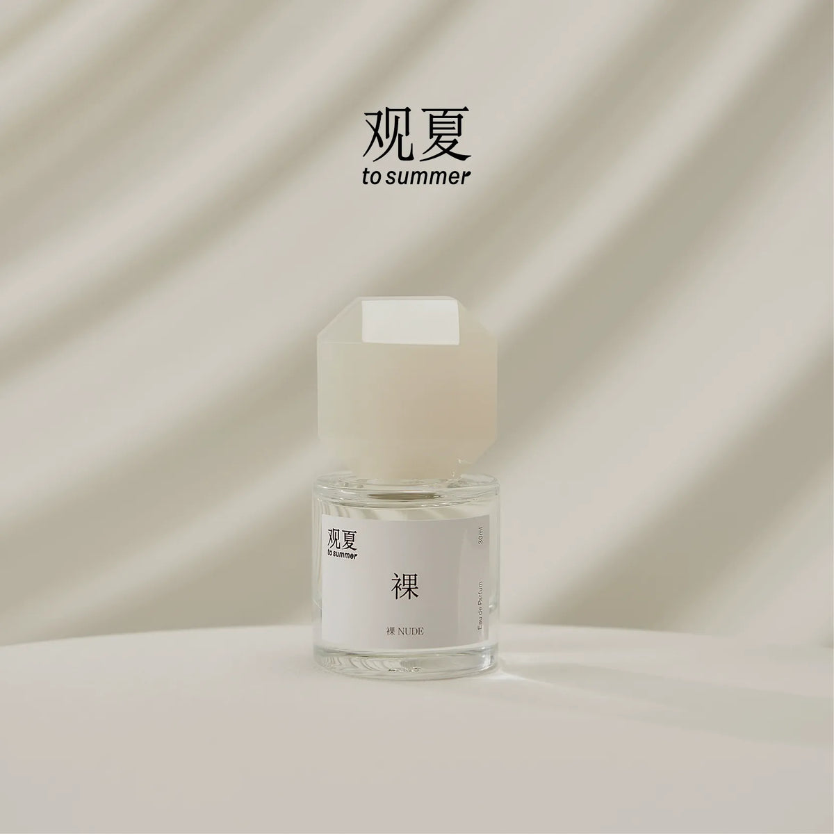 TO SUMMER Nude Eau de Parfum 30ml bottle on cream draped fabric