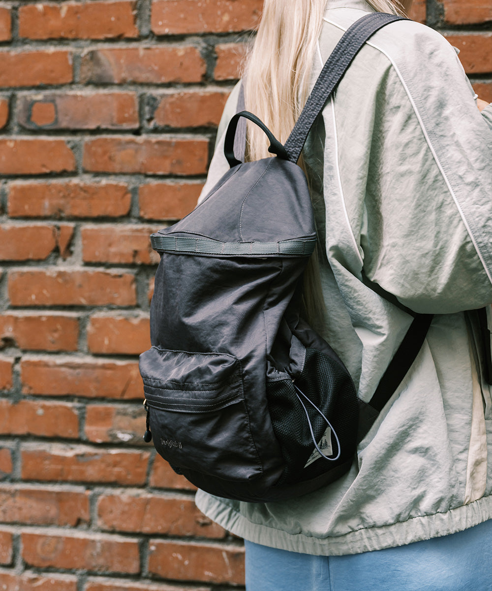 Rockfish Weatherwear Nylon Backpack dark colourway worn on the back, side view