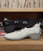 Rockfish Weatherwear Bliss Heel String Sneakers Black and Cream on a shelf