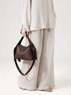 Songmont Drippy Roof Bag Burgundy - carried by hand with the strap hanging