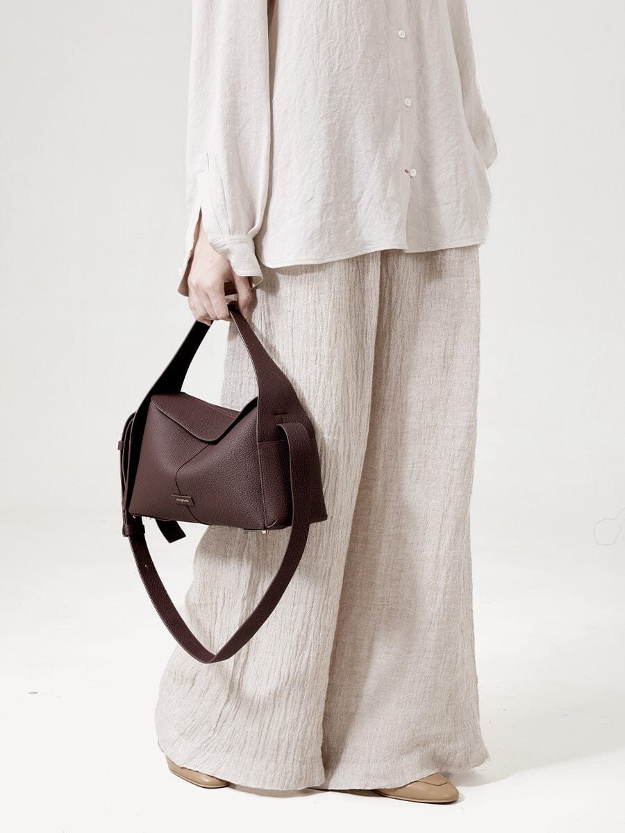 Songmont Drippy Roof Bag Burgundy - carried by hand with the strap hanging