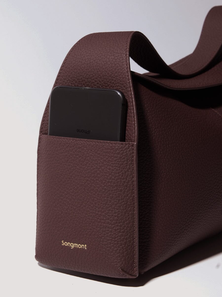 Songmont Drippy Roof Bag Burgundy - phone resting in the strap pocket, close-up