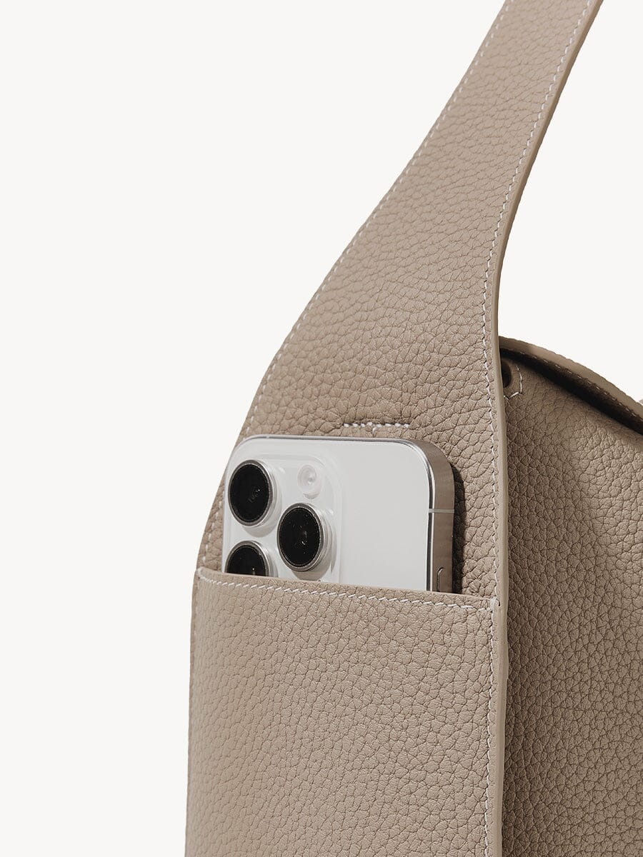 Songmont Drippy Roof Bag Cobble - phone resting in the strap pocket, close-up