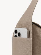 Songmont Drippy Roof Bag Cobble - phone resting in the strap pocket, close-up