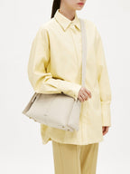 Songmont Drippy Roof Bag Ivory - worn crossbody with the strap across the body